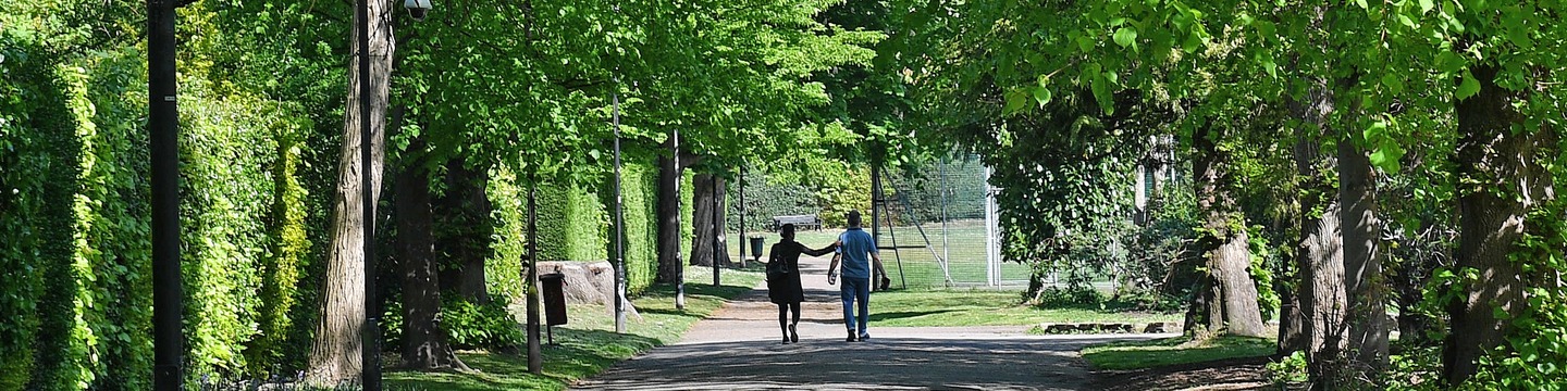 People walking through Woking Park